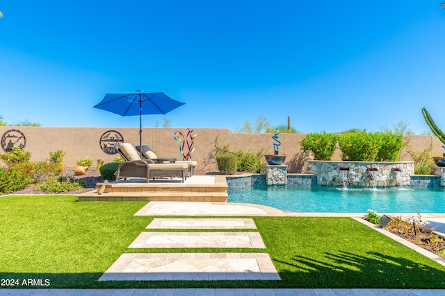 view of swimming pool with a yard and pool water feature