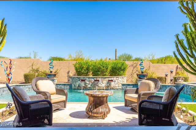 view of patio / terrace with a fenced in pool and pool water feature