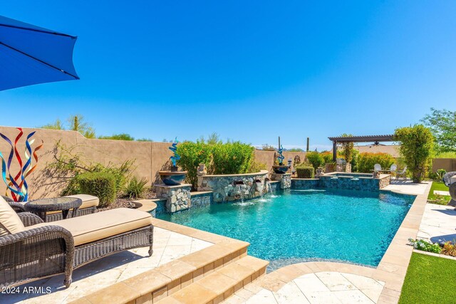 view of pool with an in ground hot tub, a patio, and pool water feature