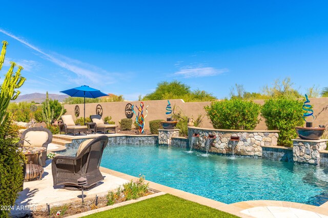 view of pool featuring pool water feature and a patio area