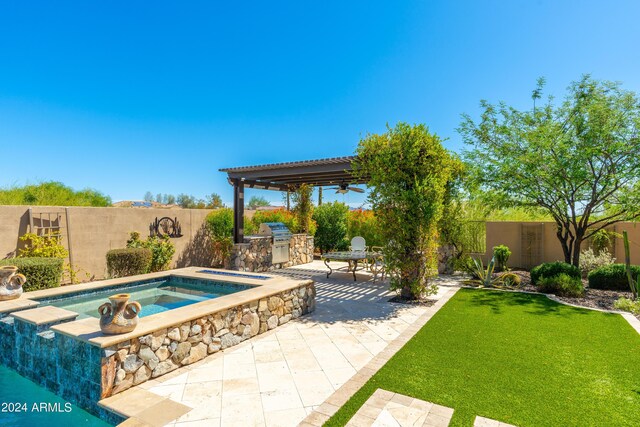 view of swimming pool featuring an in ground hot tub, exterior kitchen, a lawn, a pergola, and a patio area