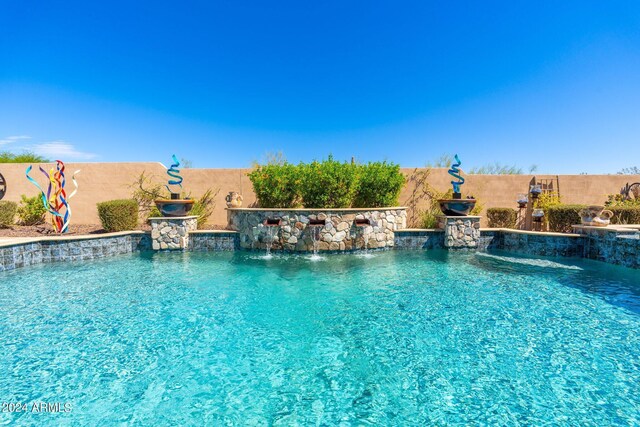 view of pool with pool water feature