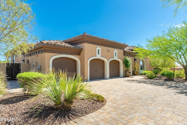 mediterranean / spanish-style home with a garage