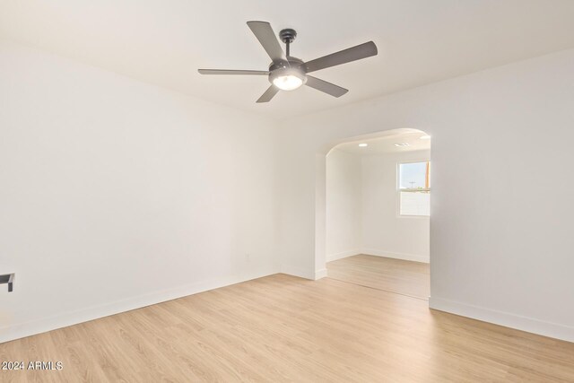 spare room featuring light wood-type flooring and ceiling fan