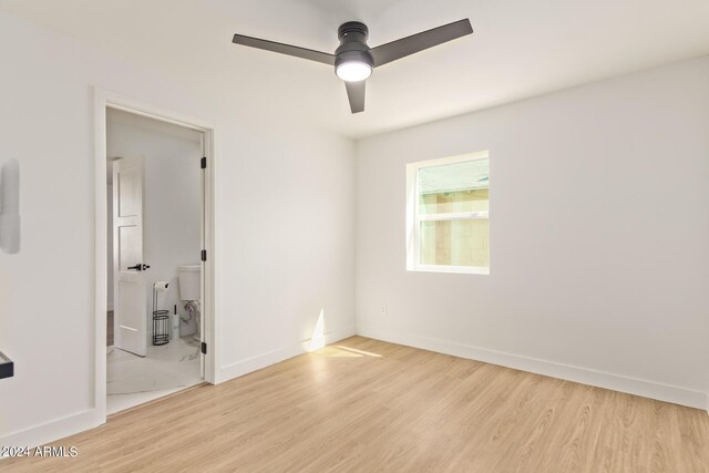 empty room featuring ceiling fan and light hardwood / wood-style floors