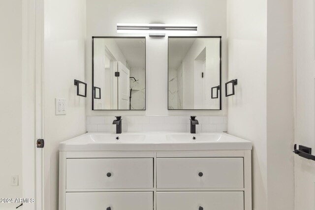 bathroom featuring tasteful backsplash and vanity