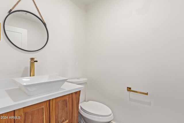 bathroom featuring vanity and toilet