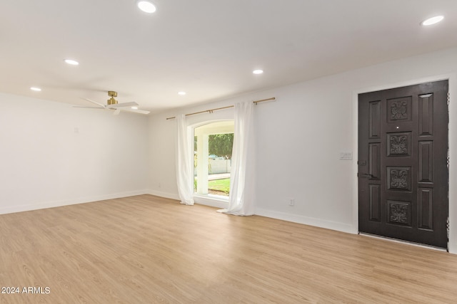 foyer with ceiling fan and light hardwood / wood-style floors