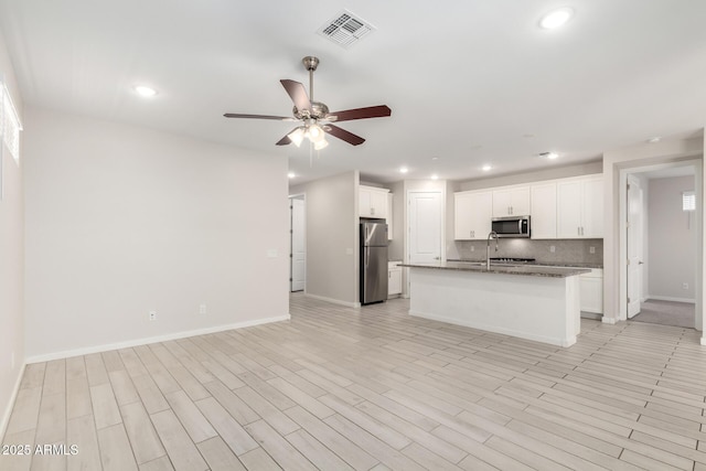 22507 E Quintero Rd, Queen Creek, AZ 85142 - kitchen featuring appliances with stainless steel finishes, open floor plan, a ceiling fan, backsplash, and recessed lighting