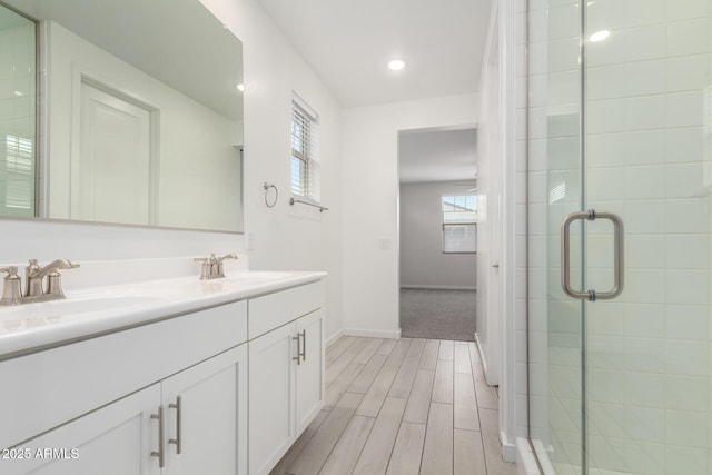 22507 E Quintero Rd, Queen Creek, AZ 85142 - bathroom with double vanity, a stall shower, wood finished floors, and recessed lighting