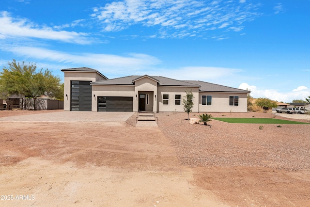 19622 W Pasadena Ave, Litchfield Park, AZ 85340 - prairie-style house with fence, an attached garage, driveway, and stucco siding