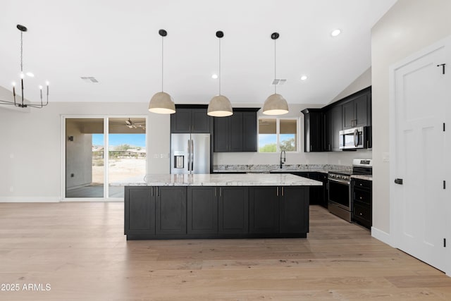 19622 W Pasadena Ave, Litchfield Park, AZ 85340 - kitchen featuring a notable chandelier, a kitchen island, a wealth of natural light, and stainless steel appliances