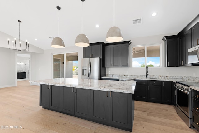 19622 W Pasadena Ave, Litchfield Park, AZ 85340 - kitchen with visible vents, a center island, a sink, appliances with stainless steel finishes, and vaulted ceiling