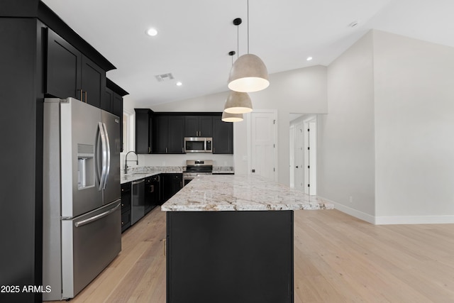 19622 W Pasadena Ave, Litchfield Park, AZ 85340 - kitchen featuring appliances with stainless steel finishes, a sink, dark cabinetry, a center island, and visible vents