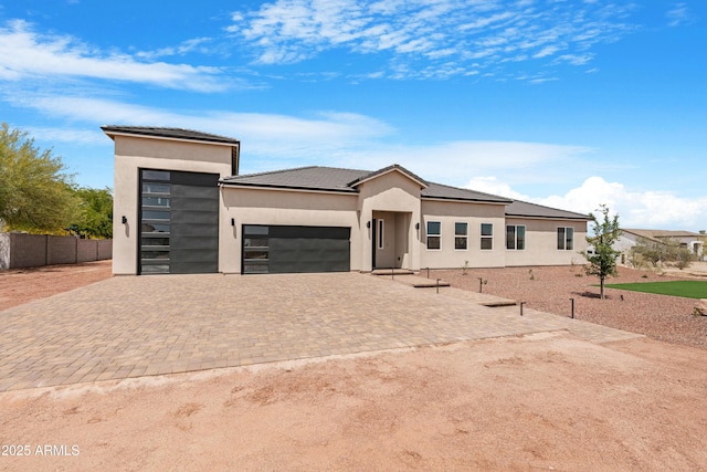 19622 W Pasadena Ave, Litchfield Park, AZ 85340 - prairie-style house featuring an attached garage, stucco siding, driveway, and fence