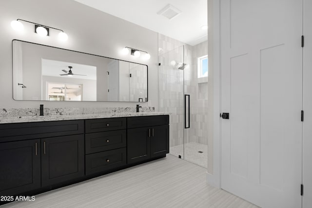 19622 W Pasadena Ave, Litchfield Park, AZ 85340 - bathroom with double vanity, a sink, ceiling fan, and a stall shower