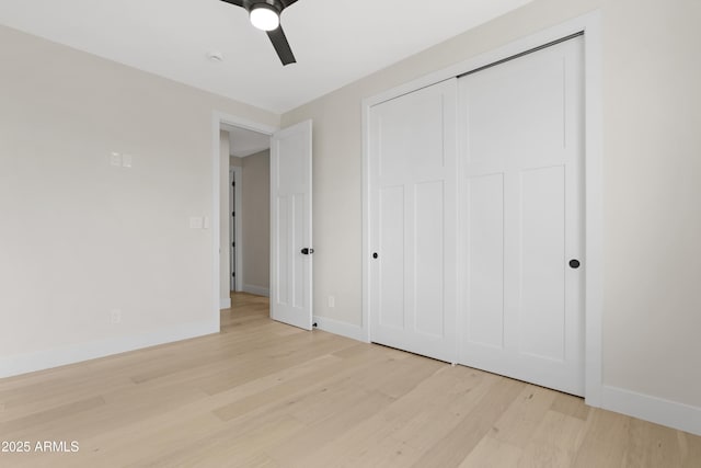 19622 W Pasadena Ave, Litchfield Park, AZ 85340 - unfurnished bedroom with baseboards, a ceiling fan, a closet, and wood finished floors