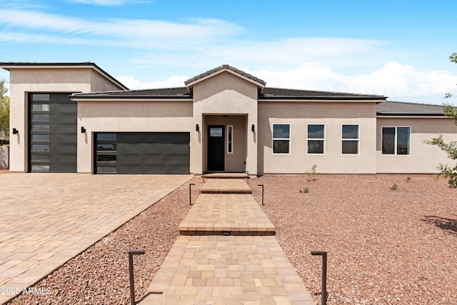 19622 W Pasadena Ave, Litchfield Park, AZ 85340 - view of front of home featuring decorative driveway, an attached garage, and stucco siding
