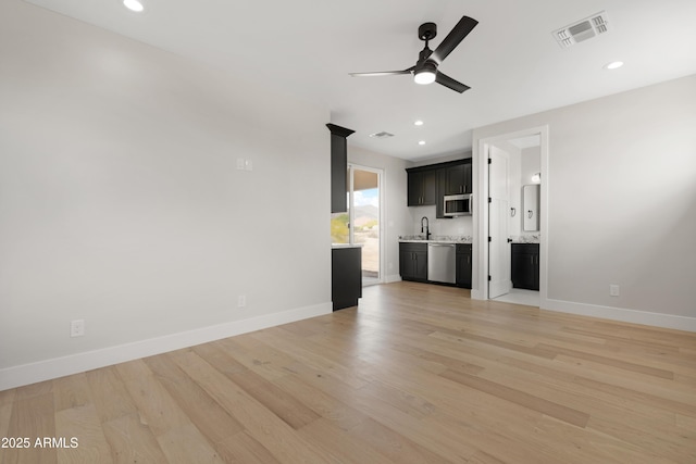 19622 W Pasadena Ave, Litchfield Park, AZ 85340 - unfurnished living room featuring light wood-style floors, a ceiling fan, baseboards, recessed lighting, and visible vents
