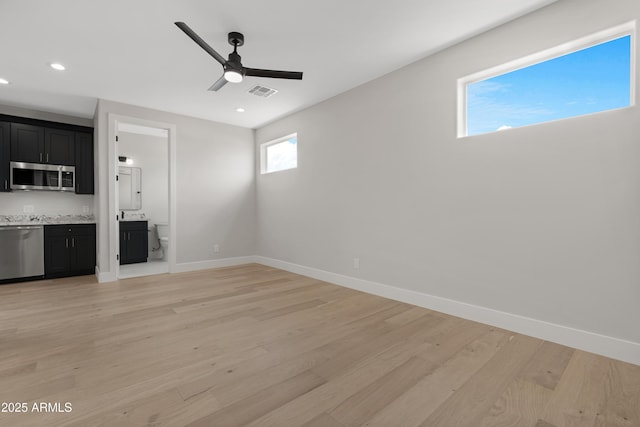 19622 W Pasadena Ave, Litchfield Park, AZ 85340 - unfurnished living room featuring light wood-style floors, baseboards, ceiling fan, and visible vents