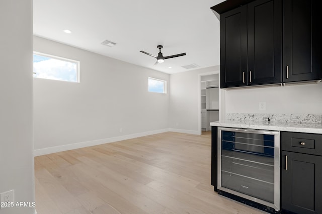 19622 W Pasadena Ave, Litchfield Park, AZ 85340 - bar with a ceiling fan, visible vents, baseboards, beverage cooler, and light wood-style floors