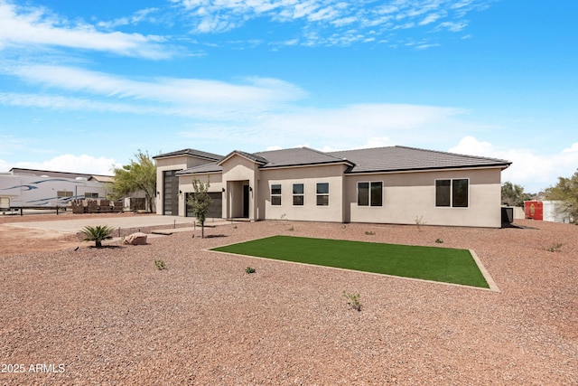 19622 W Pasadena Ave, Litchfield Park, AZ 85340 - rear view of house with an attached garage, stucco siding, driveway, and a tile roof