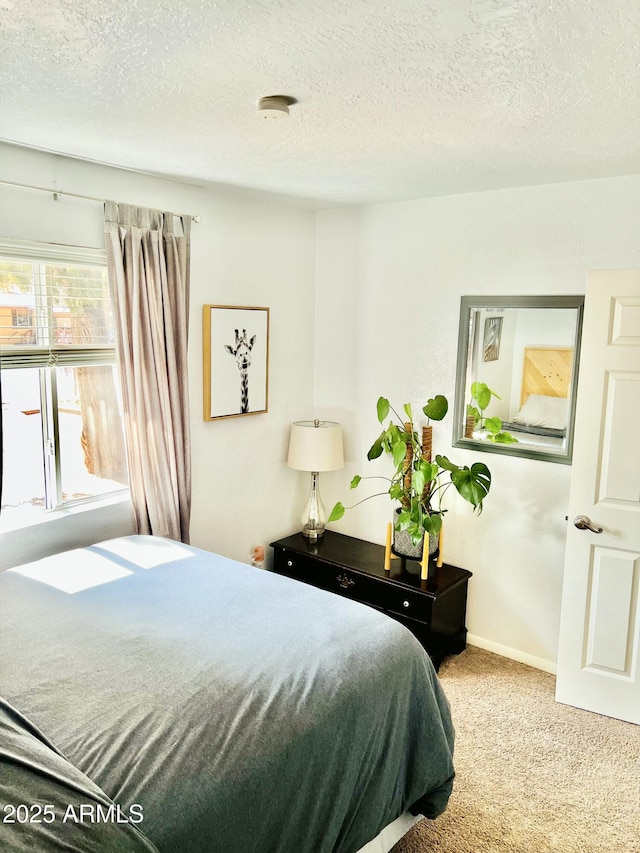 carpeted bedroom featuring a textured ceiling