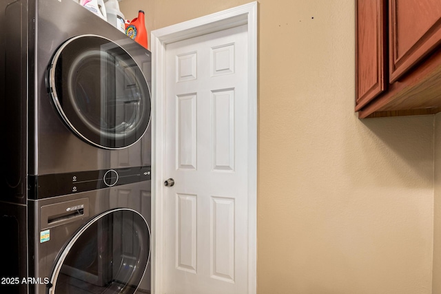 50031 N 27th Ave, New River, AZ 85087 - laundry room featuring stacked washing machine and dryer and cabinet space