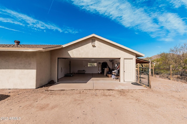 50031 N 27th Ave, New River, AZ 85087 - view of side of property with a mountain view, stucco siding, and a garage