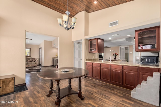 50031 N 27th Ave, New River, AZ 85087 - kitchen featuring a towering ceiling, black microwave, wooden ceiling, dark wood-type flooring, and glass insert cabinets