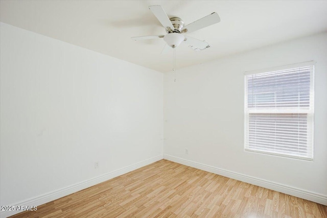 empty room with light wood-style flooring, ceiling fan, and baseboards