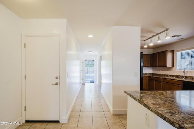 kitchen with light tile patterned floors, visible vents, dishwasher, a sink, and a healthy amount of sunlight