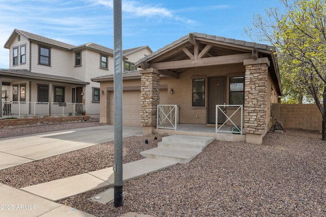 view of front of property featuring covered porch, a garage, fence, driveway, and stucco siding