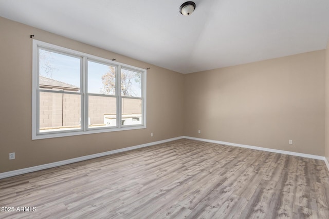 unfurnished room with light wood-style floors and baseboards