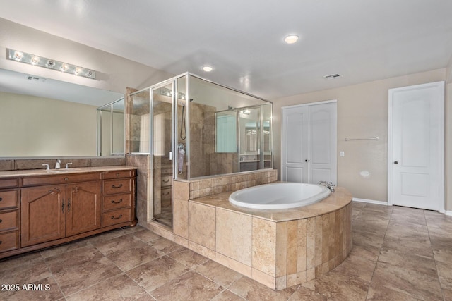 bathroom featuring visible vents, a stall shower, vanity, and a bath