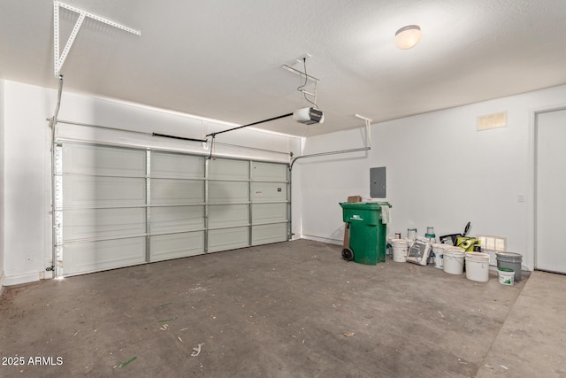 garage featuring electric panel and a garage door opener