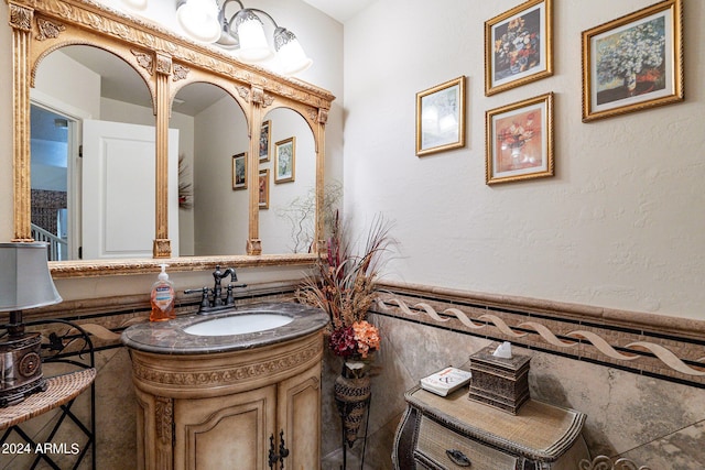 bathroom with vanity and tile walls