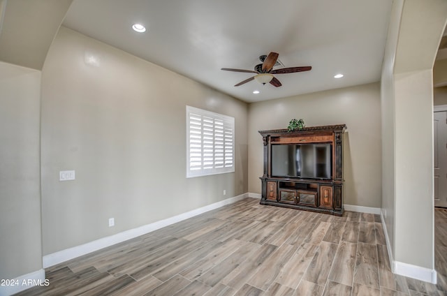 unfurnished living room featuring ceiling fan and light hardwood / wood-style floors