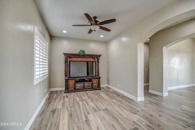 unfurnished living room with ceiling fan and light wood-type flooring