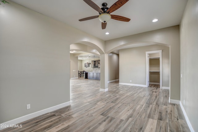 spare room with light wood-type flooring and ceiling fan