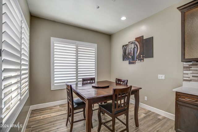 dining space with light hardwood / wood-style floors