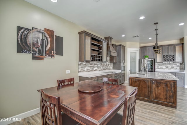 dining area featuring sink and light hardwood / wood-style flooring