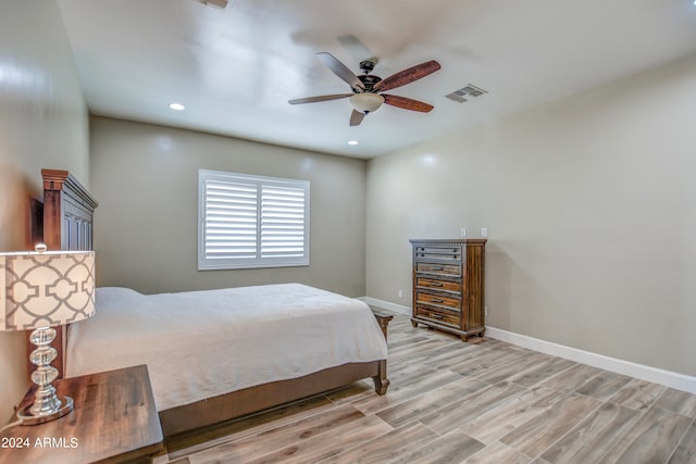 bedroom with ceiling fan and light hardwood / wood-style floors