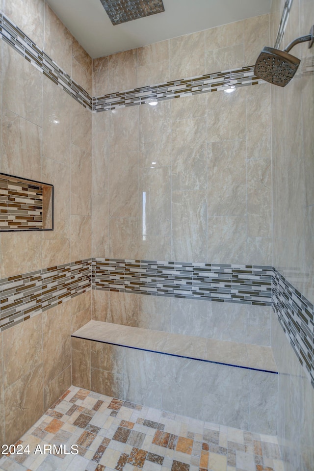 bathroom featuring a tile shower