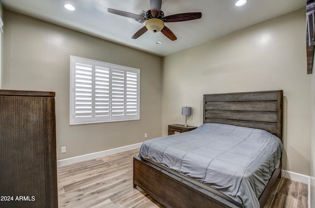 bedroom with ceiling fan and light wood-type flooring