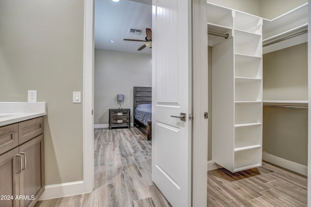 bathroom featuring ceiling fan, wood-type flooring, and vanity