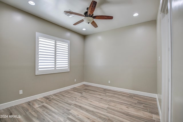 spare room featuring ceiling fan and light hardwood / wood-style floors