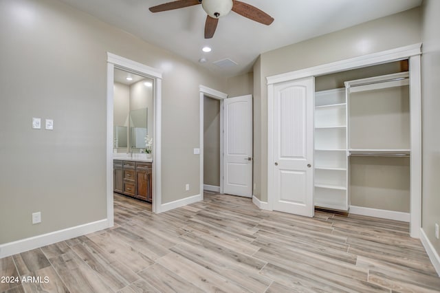 unfurnished bedroom featuring light wood-type flooring, ceiling fan, a closet, and connected bathroom