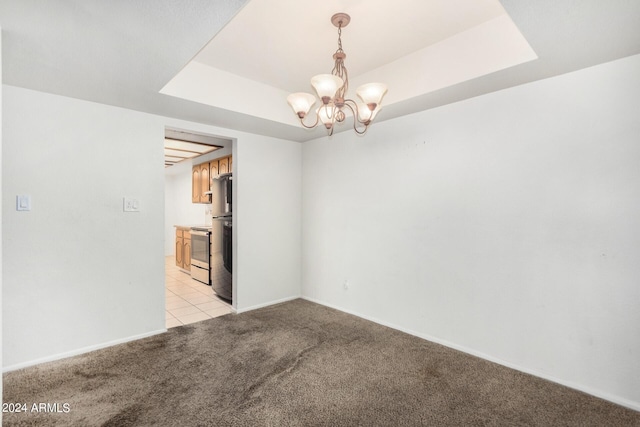 unfurnished room with a raised ceiling, baseboards, light colored carpet, and a notable chandelier