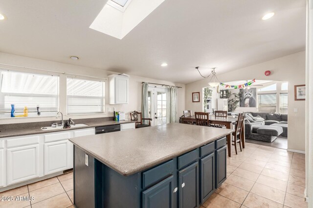 kitchen featuring sink, white cabinets, light tile patterned floors, and blue cabinets